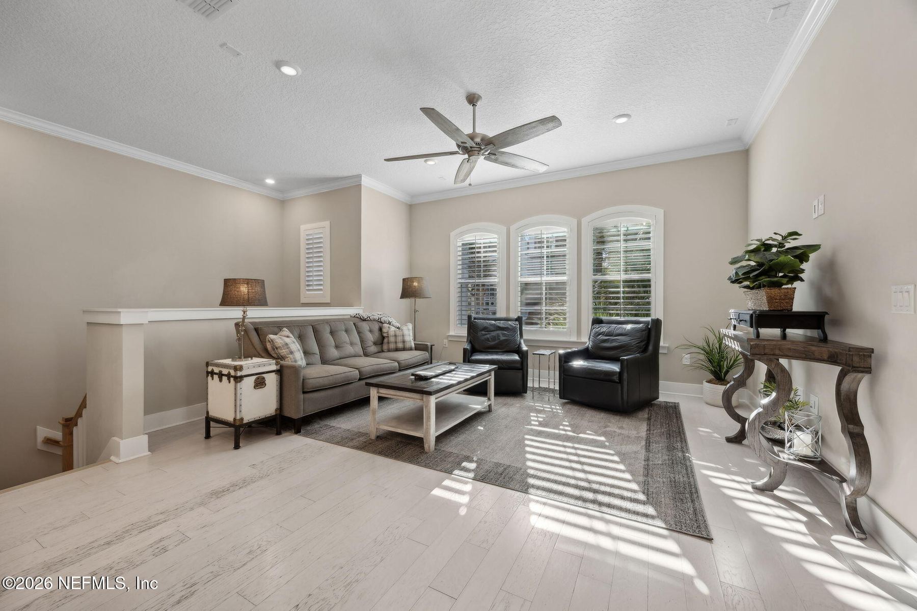 Secondary bedroom with wood floors and shutters